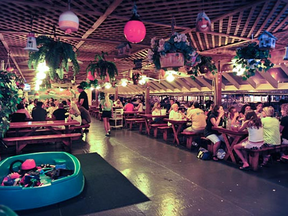 Guests dining under string lights at Carmen's