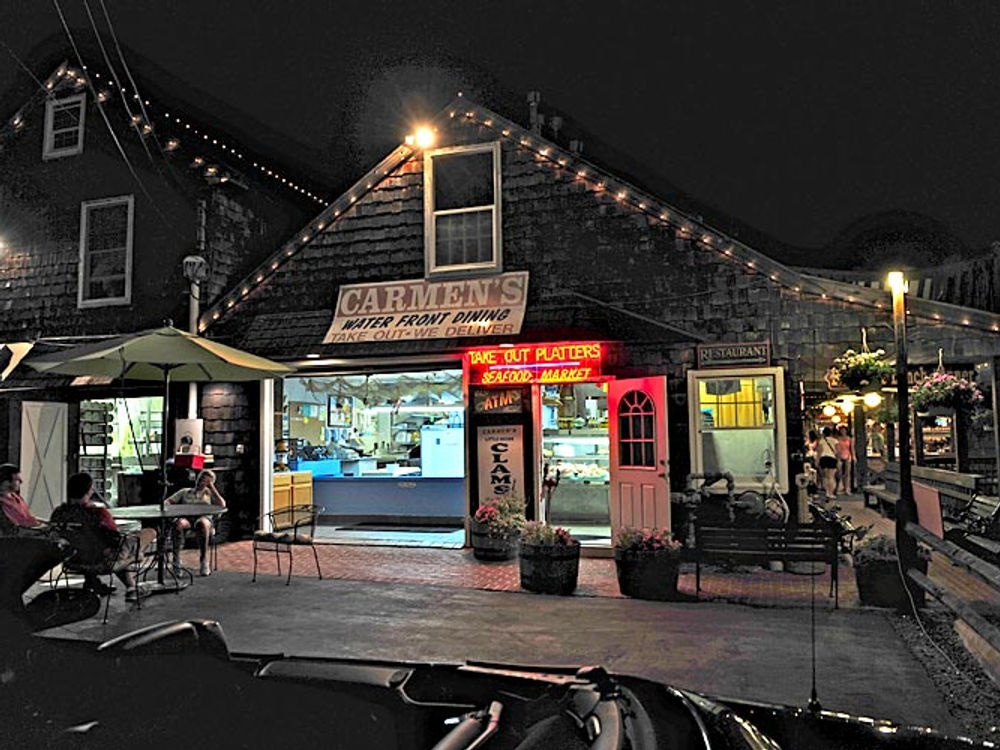 Carmen's storefront glowing at night